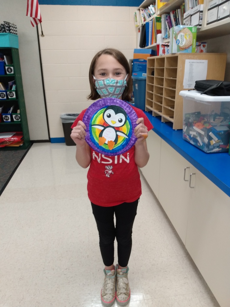 A 3rd grader displays her penguin project after a virtual visit to the Georgia Aquarium!